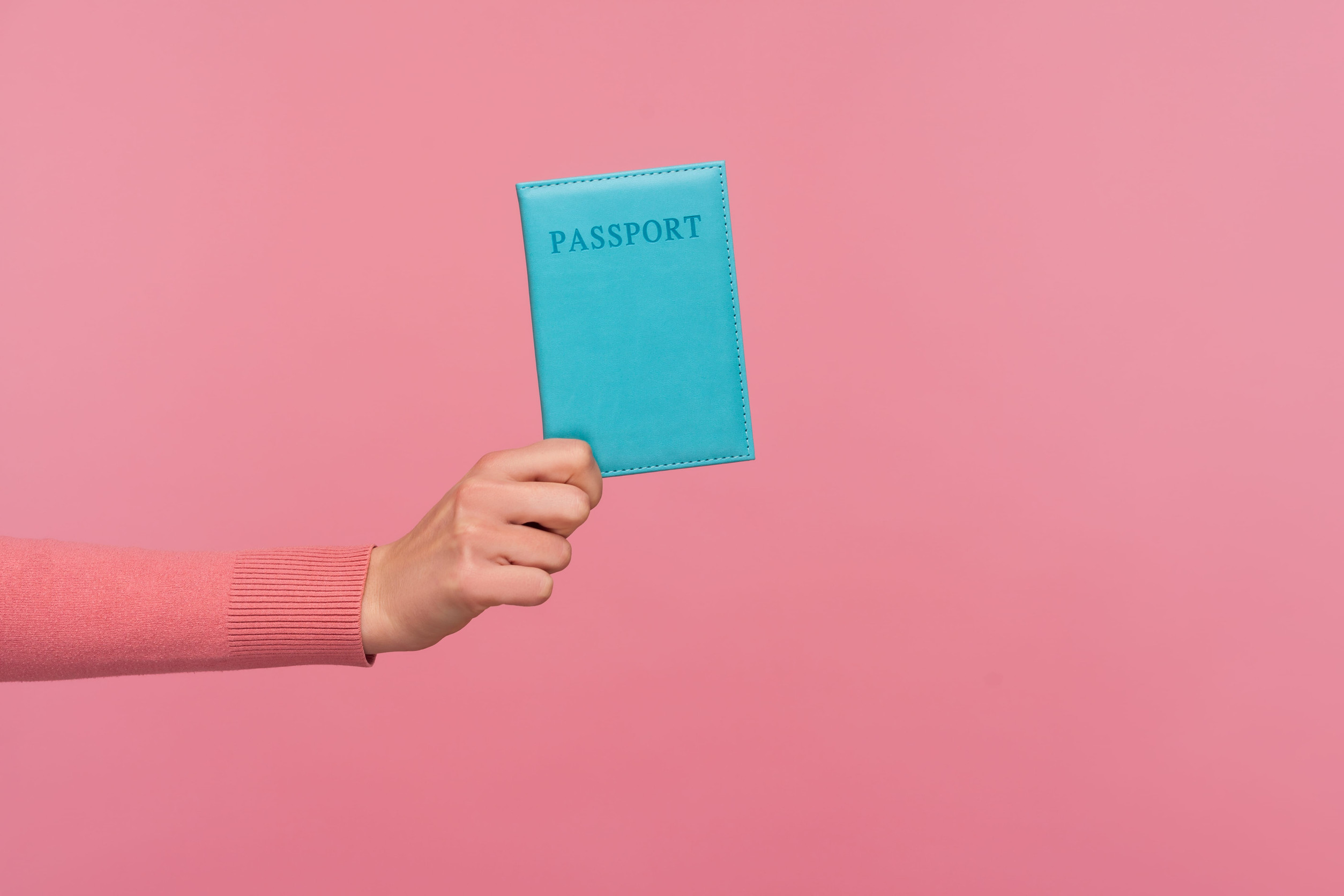 female hand holding passport visa immigration