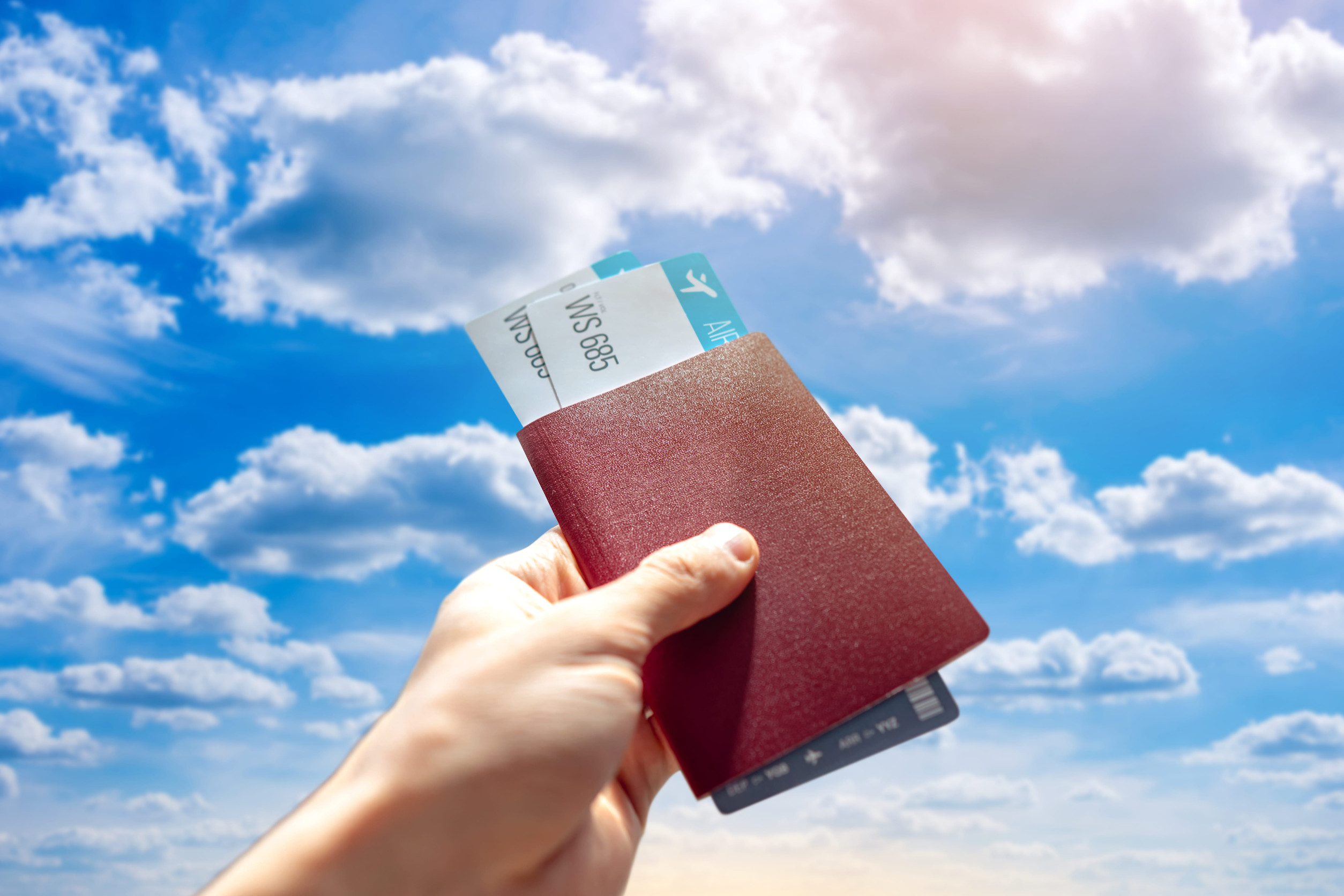 Hand Holding Passport Tickets