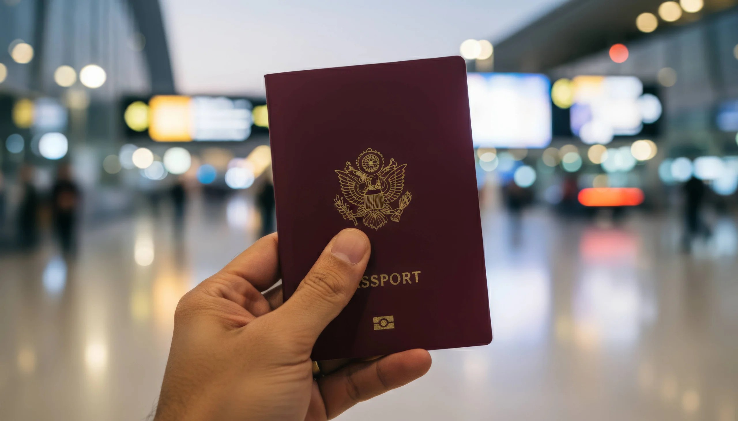 Man Holding A Dark Red Passport