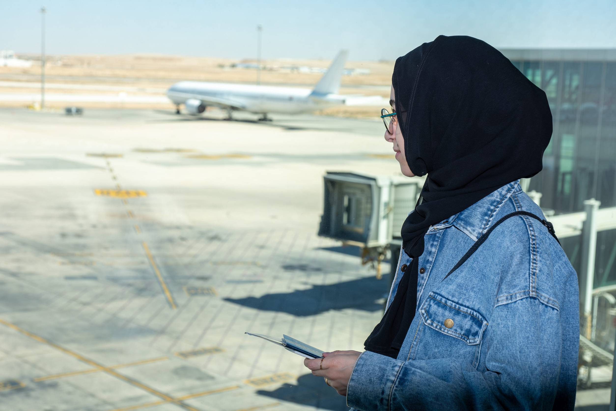 Young Female Holding Her Passport At The Airport